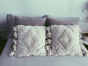 almohadas y cojines en una cama